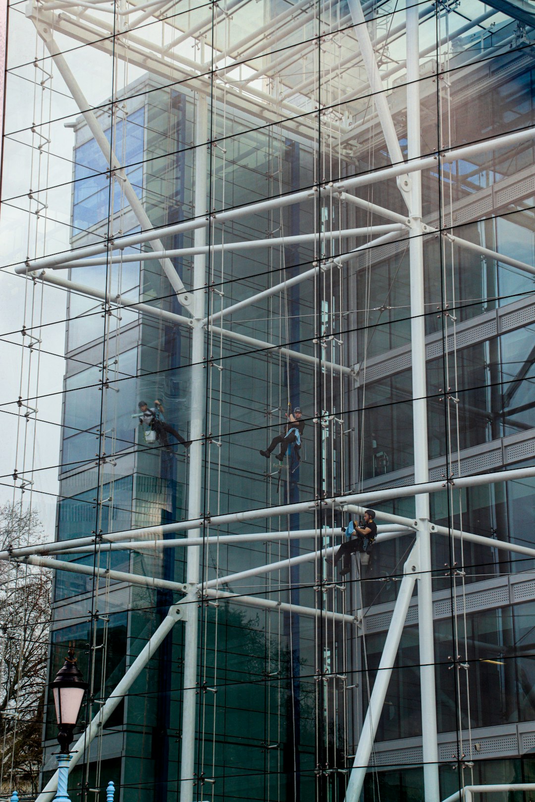 hero-img-02 Window cleaners working from ropes on the inside of a Tower Bridge House London